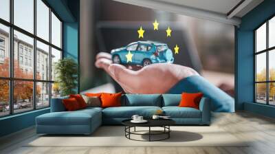 automobile, auto, vehicle, assurance, traffic, insurance, warranty, rent, driver, rental. A hand holding a blue toy car with surrounded by stars, and the image conveys a sense of luxury and prestige. Wall mural