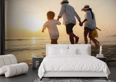 Happy asian family at consisting father, mother,son and daughter having fun playing beach in summer vacation on the beach.Happy family and vacations concept. Wall mural