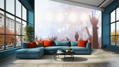 musical, party, entertainment, nightclub, festival, applauding, audience, cheer, crowd, dancing. A crowd of people are at a concert, with their hands raised in the air, everyone enjoying the music. Wall mural