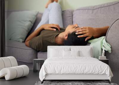 I cant do any more chores. Shot of a young woman sleeping on the couch at home. Wall mural