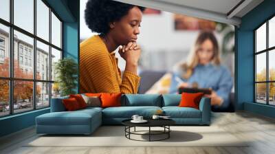 Mental health, depression and psychology with a black woman in therapy, talking to a professional. Anxiety, stress or support with a young patient in session with a psychologist for grief counseling Wall mural