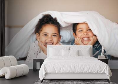 Siblings, happy and portrait of children in bed in blanket for bonding, love and fun at home. Family, childhood and face of boy and girl in bedroom for relax, resting and smile together in morning Wall mural