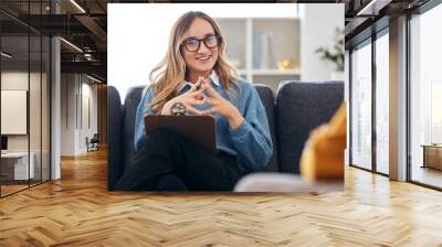 Therapist on sofa with notes, listening to patient in therapy and advice in psychology for mental health care. Conversation, support and woman on couch with client, happy psychologist in counseling. Wall mural