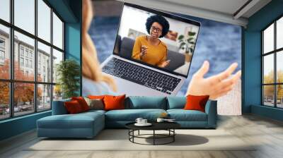 Woman, video call and psychologist on laptop screen of support, advice or helping with mental health in online meeting. African therapist talking to home client for remote therapy on computer Wall mural