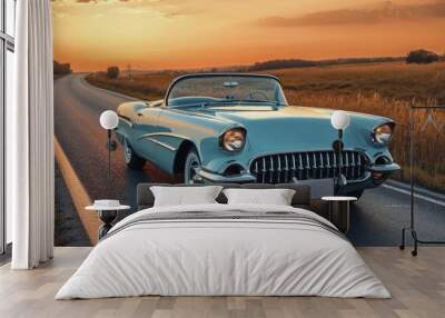 Vintage Blue Convertible Car Driving on a Road at Sunset Wall mural