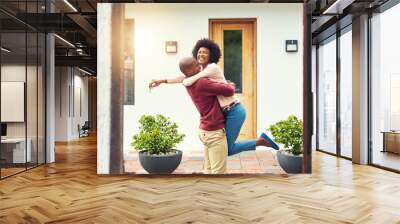 Finally a home of our own. Shot of a young couple celebrating the move into their new house. Wall mural