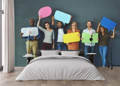 Let us help you get your word out. Studio shot of a diverse group of people holding up speech bubbles against a gray background. Wall mural