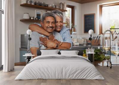 Our home is filled to the brim with love. Portrait of a happy mature couple cooking a meal together at home. Wall mural