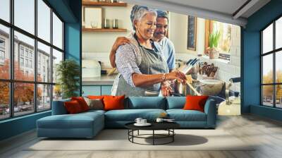 Putting the heart into a hearty meal. Shot of a happy mature couple cooking a meal together at home. Wall mural