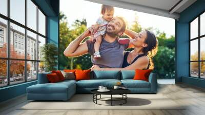 Together we make a family. Shot of a young family outdoors. Wall mural