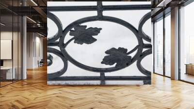 Artistic forging. Part of the forged fence. Leaves from metal. Wall mural