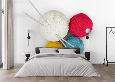 Four balls of multi-colored yarn and knitting needles isolated on a transparent background. Wall mural