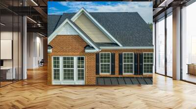 Beautiful luxury American colonial traditional estate model home on a new development with two car garage,  brick siding, fiber cement shingle gable roof , double hung windows with matching shutters  Wall mural