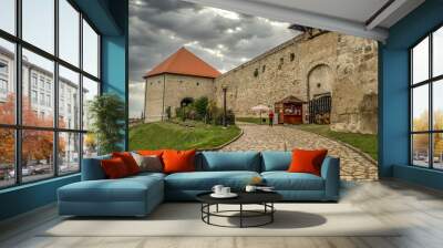 View of Varkoch gate tower and Hyppolite gate in Eger castle in Hungary with stormy gray sky Wall mural