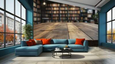 Empty wooden table top with a blurred background of bookshelves Wall mural