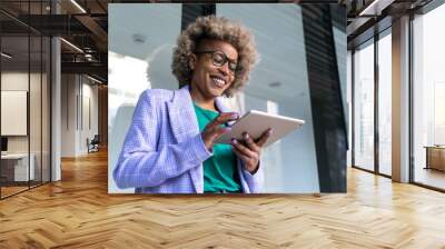  Young African American business woman working with digital tablet  Wall mural