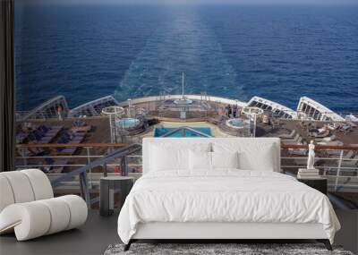 View from open outdoor deck of legendary luxury ocean liner cruise ship on passage during Transatlantic Crossing from Southampton to New York with deck chairs, railing and superstructure Wall mural