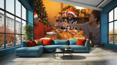 A group of African American black family, women girl have a celebration dinner in party on Merry Christmas Eve Xmas on holiday at home or house. People lifestyle. Happy New Year Wall mural