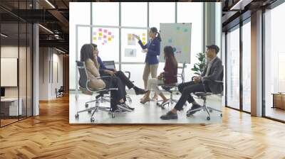 A group of Asian business team talk, communicate, discuss, and work in meeting room office, present ideas to colleagues. People lifestyle. Corporation Wall mural