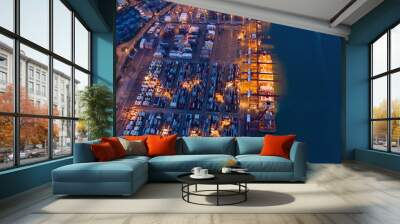 Aerial top view of container cargo ship in the export and import business and logistics international goods in urban city. Shipping to the harbor by crane in Victoria Harbour, Hong Kong City at night. Wall mural