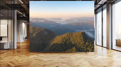 Aerial top view of forest trees and green mountain hills with sea fog, mist and clouds. Nature landscape background, Thailand. Wall mural