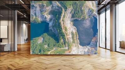 Aerial view of Grand Canyon Chonburi. Trucks dig coal mining or ore with black grunge ground in quarry with mountain hills. Nature landscape background in factory industry. Environment resources. Wall mural