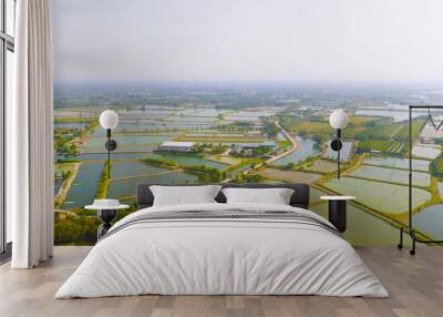 Aerial view of natural sea salt ponds, lake or sea. Farm field outdoor in traditional industry in Thailand. Asia culture. Agriculture irrigation. River reflection. Wall mural