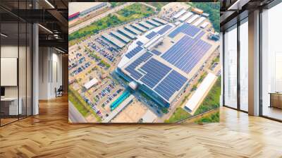 Aerial view of solar panels or solar cells on the roof of shopping mall building rooftop. Power plant, renewable clean energy source. Eco technology for electric power in industry. Wall mural