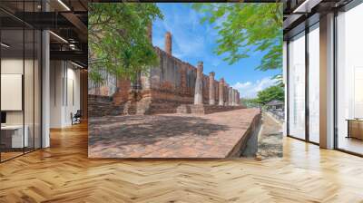 Old ruins of a temple in Phra Nakhon Si Ayutthaya province near Bangkok, Thailand. An old buddha statue in ancient temple. Famous tourist attraction landmark. History of Thai architecture. Wall mural