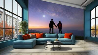 Portrait of an Asian couple, tourists, travel at Doi Tung, Chiang Rai, Thailand with mountain hills, the milky way in galaxy with stars at night. Universe space landscape background. People lifestyle. Wall mural