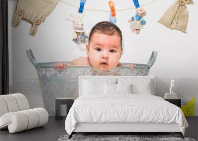 baby girl bathes in a  trough Wall mural