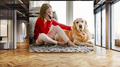 Preteen girl with golden retriever dog Wall mural