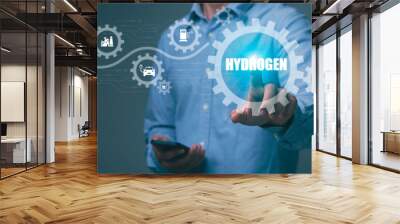 Businessman pressing icon on virtual screen with word hydrogen Green concepts, industry, nature and alternative energy. Green energy in the future Wall mural