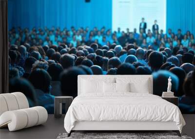 A beautiful crowd of people in the audience at a business conference on stage with a speaker, with blue colors Wall mural