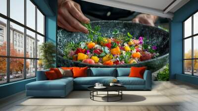 A chef is preparing a salad in a black bowl Wall mural