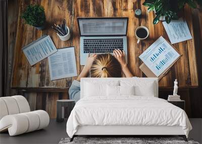 Woman Working on Laptop at Wooden Desk with Documents Wall mural