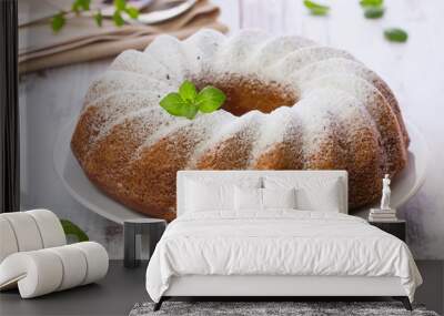 Vanilla and chocolate cake with mint laves  on wooden table Wall mural