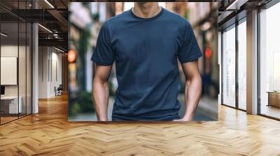 A plain dark blue tightfit tshirt mockup on an attractive young male model with good posture and happy expression Wall mural