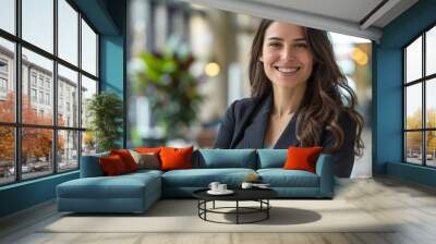 Happy professional woman with arms crossed in an urban office setting Wall mural