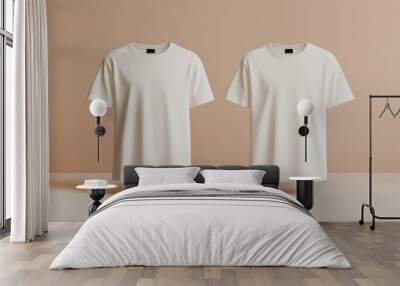 Two white t-shirts displayed on a soft beige background, minimalist design. Wall mural