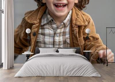 Cheerful child in stylish clothes running Wall mural