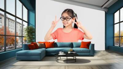 Asian girl cute Smiling child holds up two fingers Wall mural