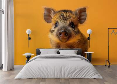 Adorable piglet with brown fur in a heartwarming close-up against a vibrant orange background, showcasing its cute features and curious expression. Wall mural