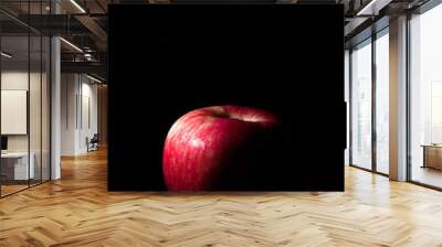 fresh red apple On a black background with water droplets, lights are falling with space for text. Wall mural