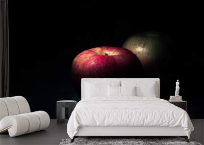 two fresh red apples On a black background with water droplets, lights are falling with space for text. Wall mural