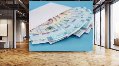 1000 hryvnia in a white envelope on a blue background. Close-up. Wall mural