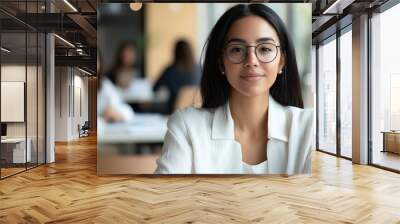 A professional Spanish-American lady confidently leading a diverse business team, engaging with her colleagues in a collaborative workspace. photo Wall mural