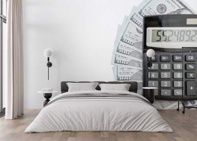 calculator with dollars on a light wooden background. Copy space. Financial concept. Wall mural