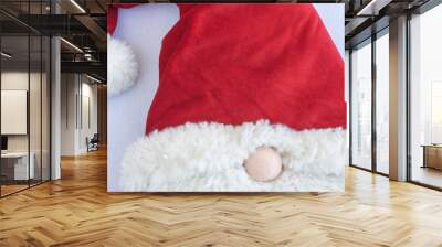 Close-up of Santa Claus hat on fabric on black background Wall mural