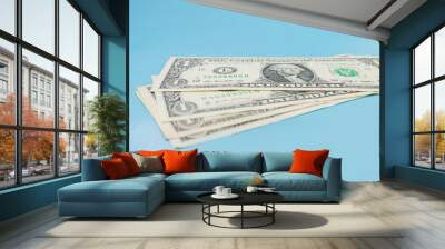 one US dollar bills on a blue background. Wall mural